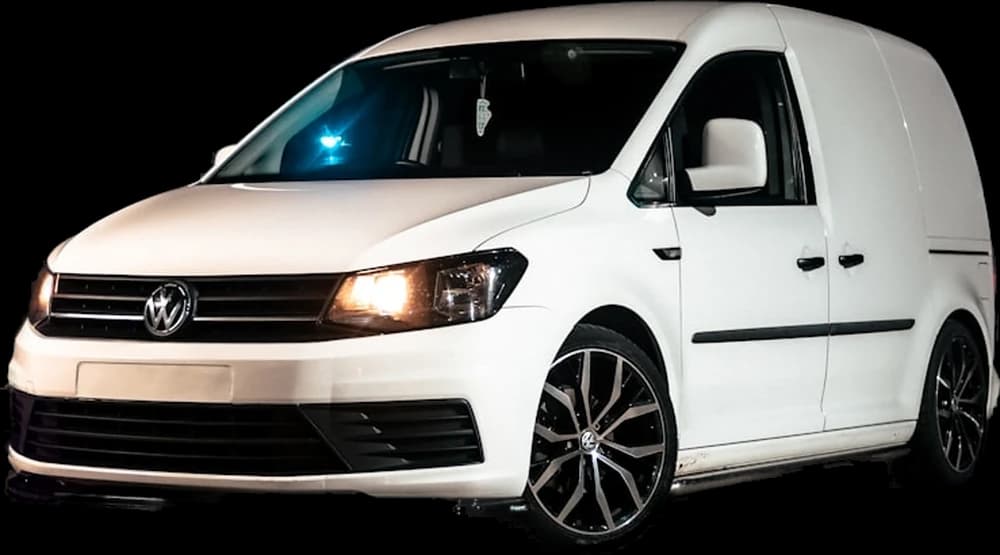 A tuned white VW Caddy van on lowered alloy wheels